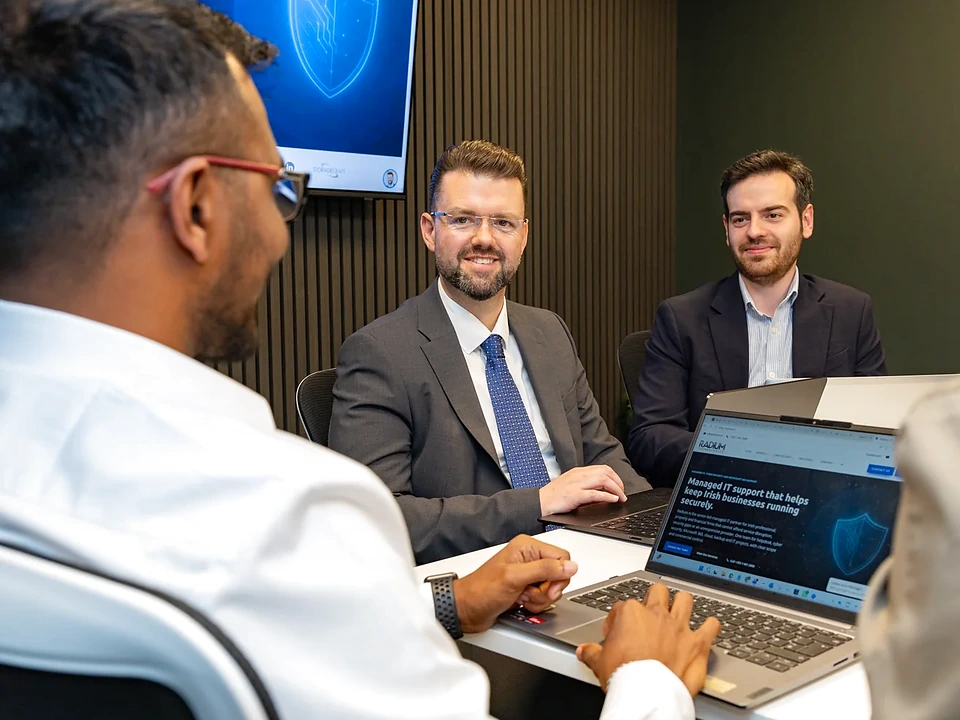 Radium engineers reviewing a client IT environment on laptops