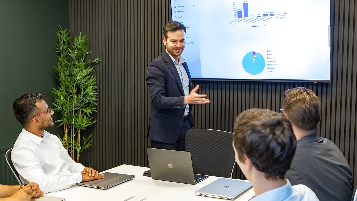 A Radium consultant presenting IT findings to a client team